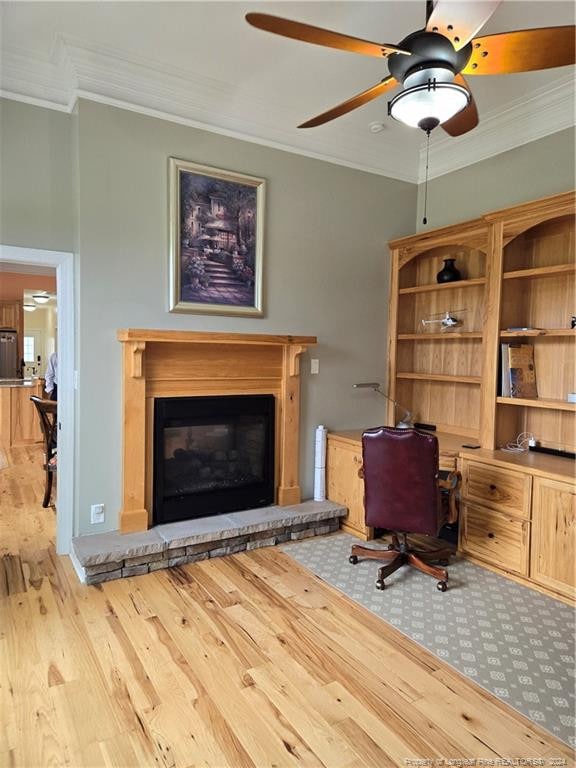 office area featuring ceiling fan, light wood-type flooring, and crown molding