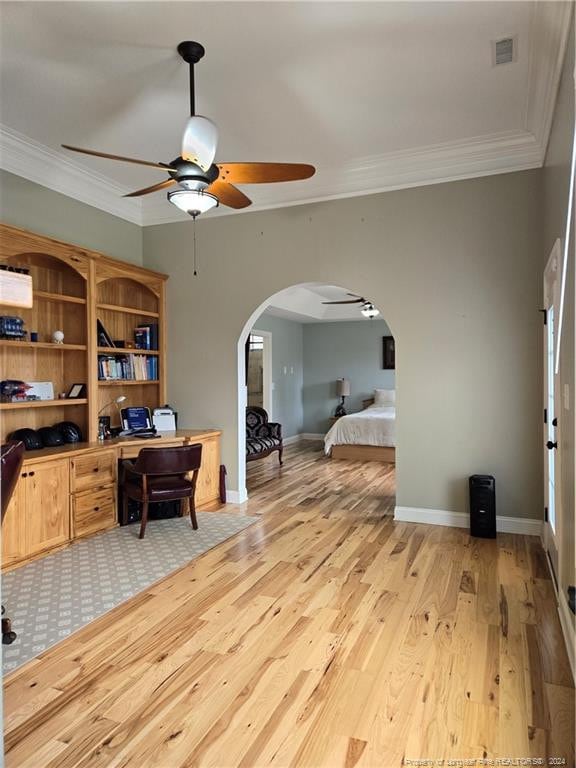 home office with ornamental molding, ceiling fan, and light hardwood / wood-style flooring