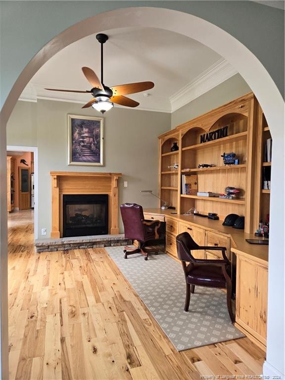 interior space with ceiling fan, crown molding, and light wood-type flooring