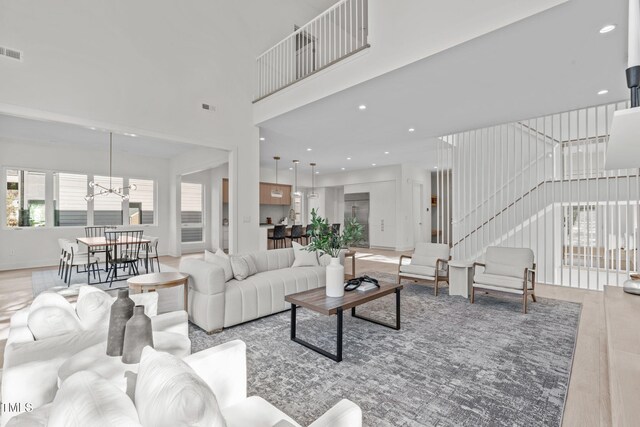 1435 Duplin Rd, Raleigh, NC 27607 - living room featuring a towering ceiling, a chandelier, and recessed lighting