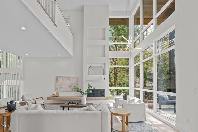 1435 Duplin Rd, Raleigh, NC 27607 - living room with a towering ceiling, a glass covered fireplace, and recessed lighting