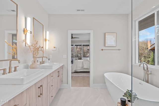 1435 Duplin Rd, Raleigh, NC 27607 - ensuite bathroom featuring plenty of natural light, double vanity, a freestanding bath, and baseboards