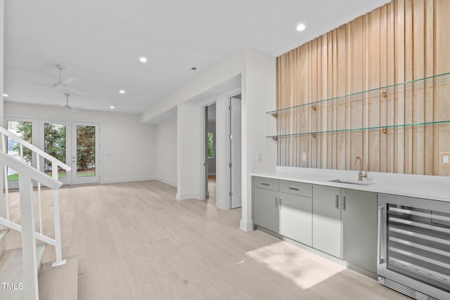 1435 Duplin Rd, Raleigh, NC 27607 - indoor wet bar featuring beverage cooler, light wood-style floors, a ceiling fan, stairs, and recessed lighting