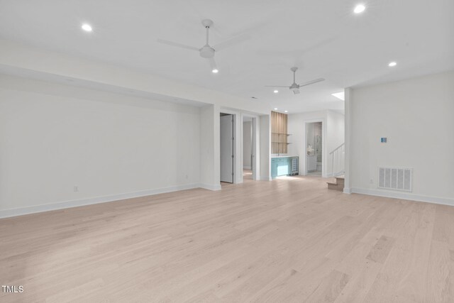 1435 Duplin Rd, Raleigh, NC 27607 - empty room featuring ceiling fan, recessed lighting, light wood-type flooring, baseboards, and stairs