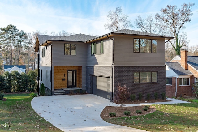 view of front of home featuring a garage and a front lawn