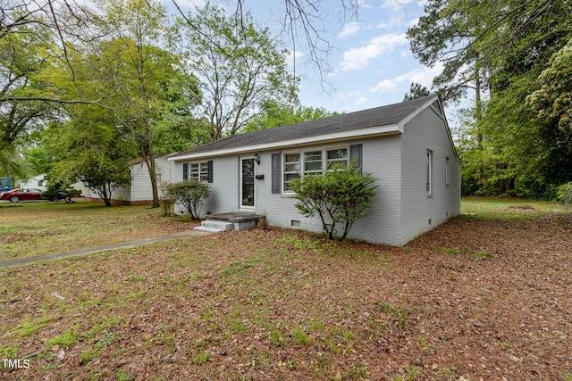 ranch-style house with a front lawn