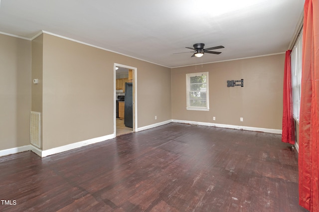 spare room with dark hardwood / wood-style floors, ornamental molding, and ceiling fan