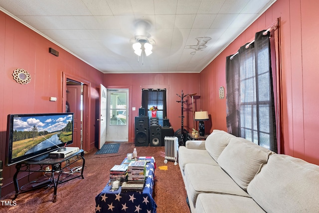 carpeted living room with ceiling fan and ornamental molding