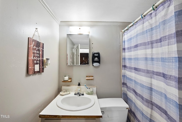 bathroom with crown molding, toilet, and vanity