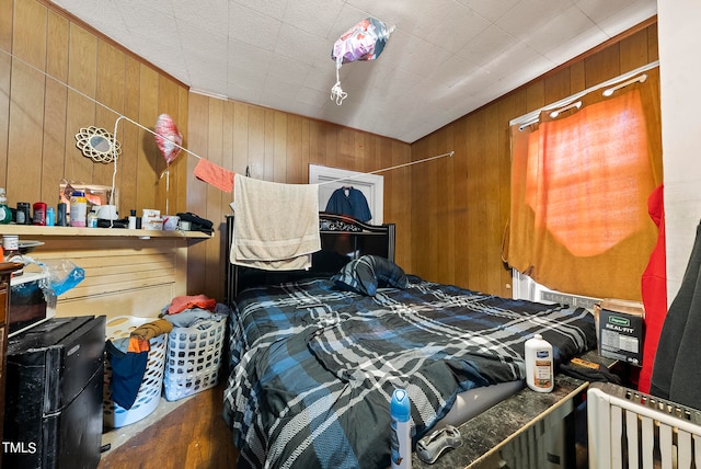 bedroom featuring dark wood-type flooring and wood walls