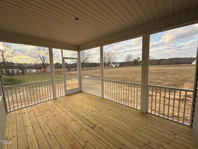 unfurnished sunroom with a rural view