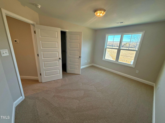 unfurnished bedroom featuring light colored carpet