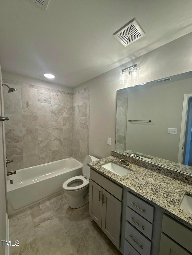 full bathroom with vanity, toilet, and tiled shower / bath