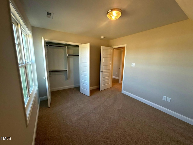 unfurnished bedroom featuring carpet floors and a closet