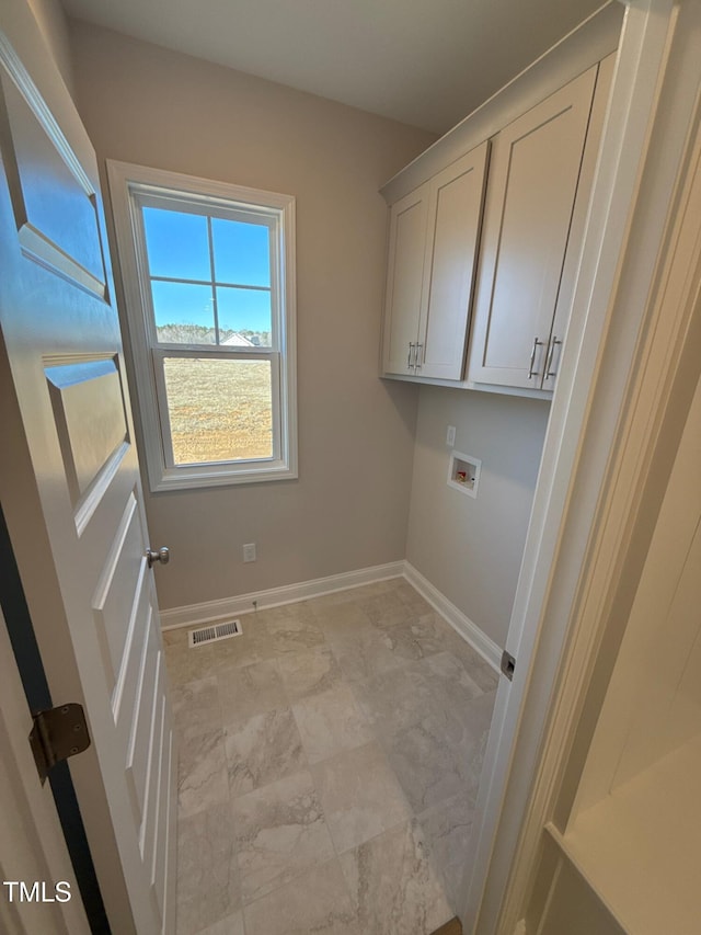 clothes washing area with cabinets and hookup for a washing machine