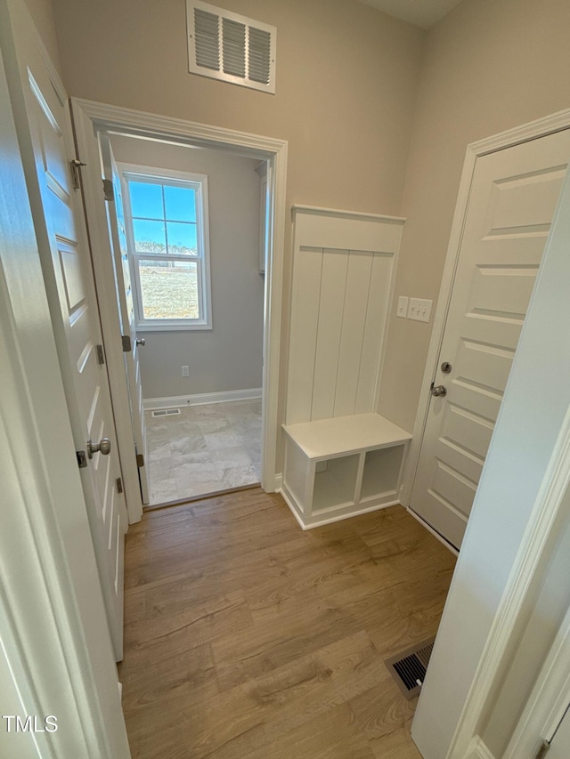 mudroom with light hardwood / wood-style flooring