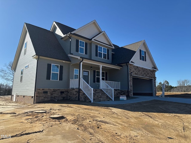 craftsman inspired home with a garage and a porch