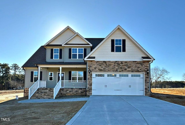 craftsman inspired home with a garage and a porch