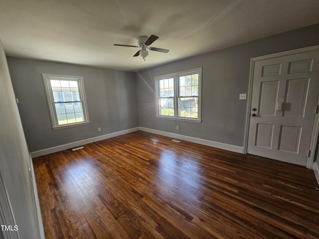 910 Marshall St, Roanoke Rapids, NC 27870 - empty room featuring dark hardwood / wood-style flooring, ceiling fan, and a healthy amount of sunlight