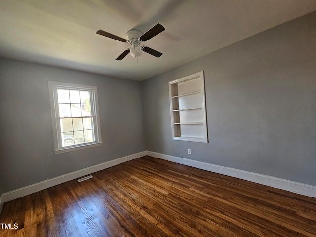 910 Marshall St, Roanoke Rapids, NC 27870 - spare room with ceiling fan, built in shelves, and dark hardwood / wood-style floors