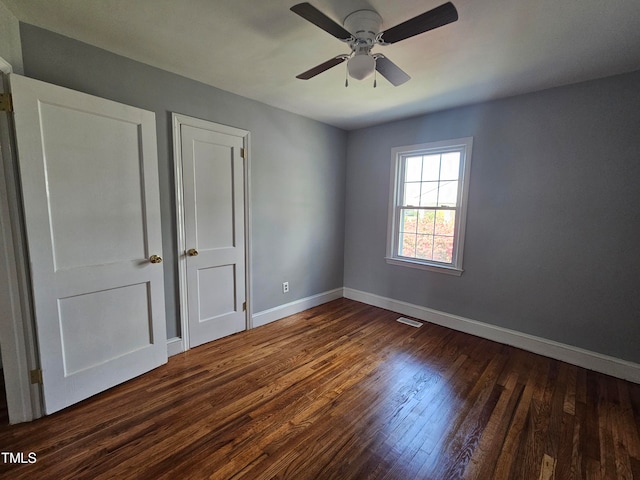 910 Marshall St, Roanoke Rapids, NC 27870 - unfurnished bedroom featuring dark wood-type flooring and ceiling fan