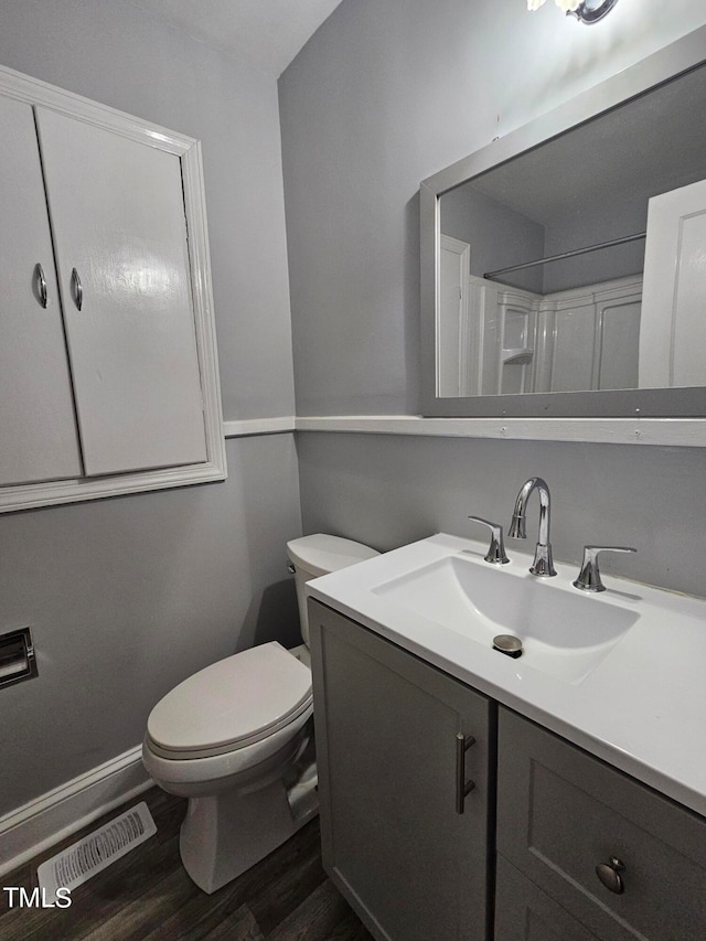 910 Marshall St, Roanoke Rapids, NC 27870 - bathroom featuring toilet, vanity, hardwood / wood-style floors, and walk in shower