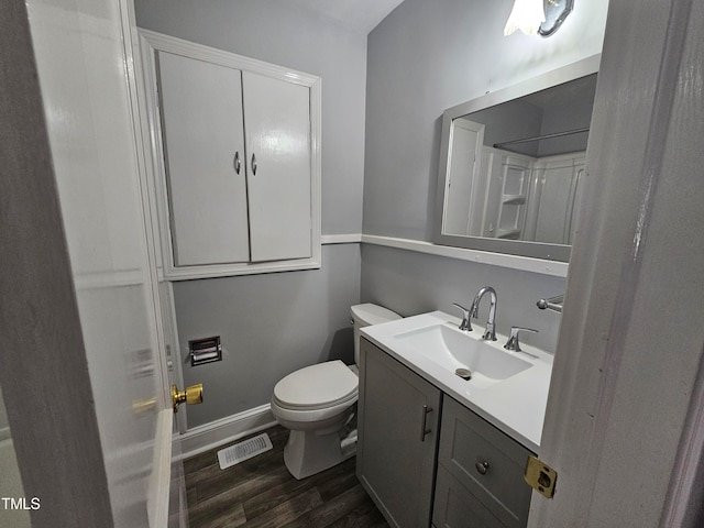 910 Marshall St, Roanoke Rapids, NC 27870 - bathroom with vanity, toilet, and hardwood / wood-style floors
