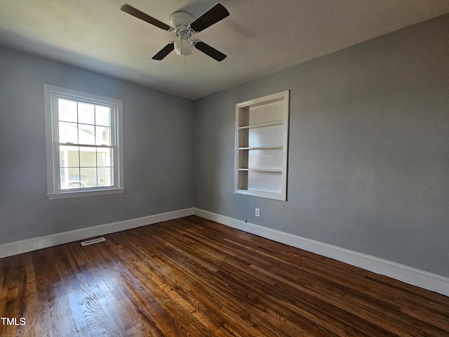 910 Marshall St, Roanoke Rapids, NC 27870 - unfurnished room with ceiling fan, dark hardwood / wood-style floors, and built in shelves