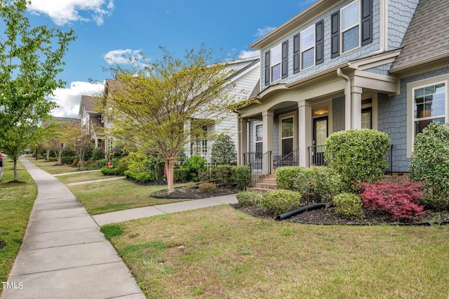 view of front facade with a front lawn and a porch