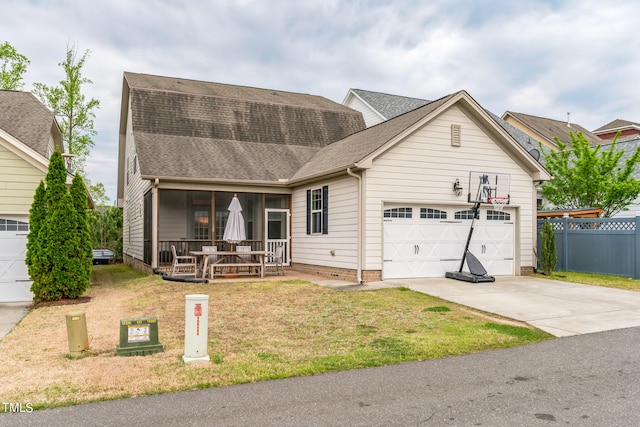 view of front of property featuring a front yard, a garage, and covered porch