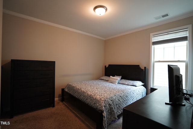 bedroom featuring ornamental molding and dark carpet