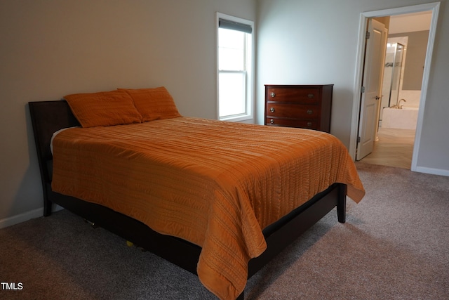 carpeted bedroom featuring ensuite bathroom