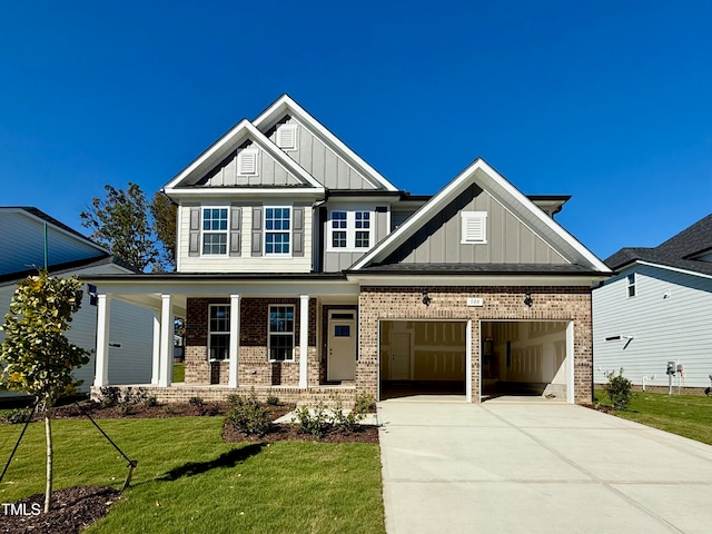 craftsman-style house with a front yard, covered porch, and a garage