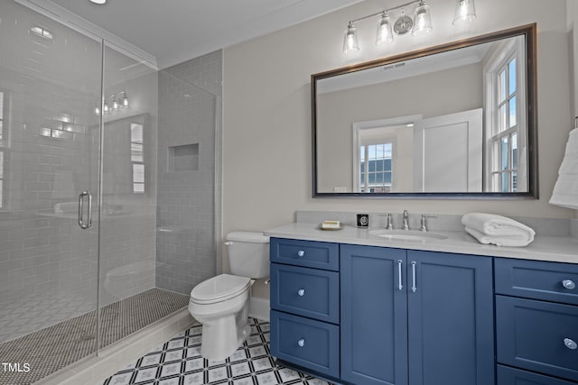 bathroom with ornamental molding, plenty of natural light, vanity, and toilet