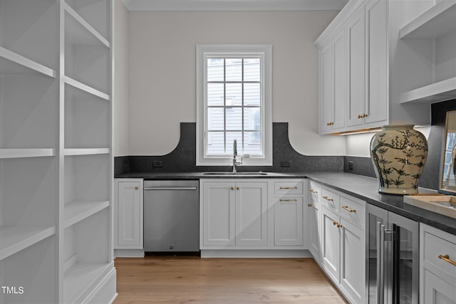 kitchen featuring wine cooler, sink, white cabinetry, dishwasher, and light wood-type flooring