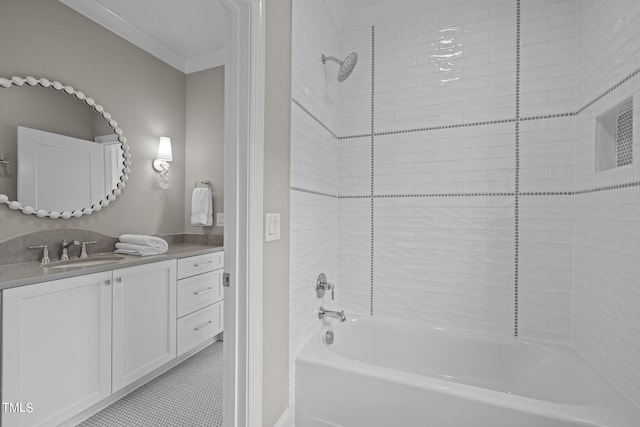 bathroom featuring ornamental molding, tile patterned floors, tiled shower / bath, and vanity