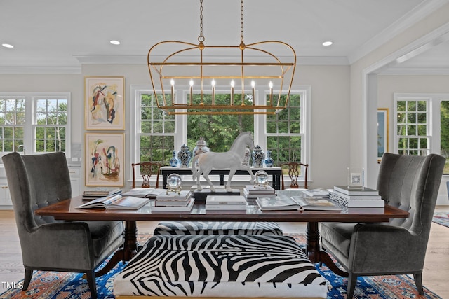 dining area featuring an inviting chandelier, light hardwood / wood-style flooring, ornamental molding, and a healthy amount of sunlight