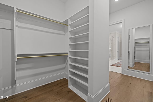 spacious closet featuring hardwood / wood-style floors