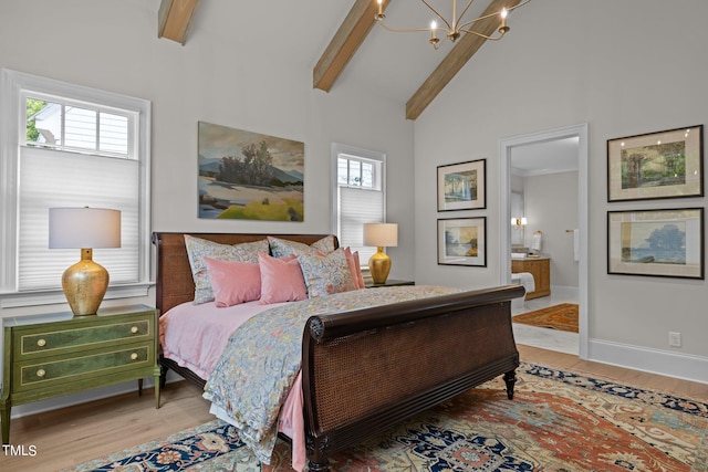 bedroom featuring light hardwood / wood-style floors, beam ceiling, ensuite bathroom, and high vaulted ceiling