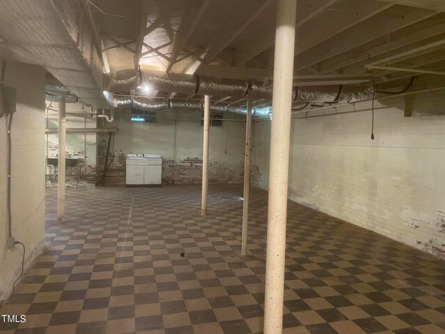 basement featuring dark tile flooring