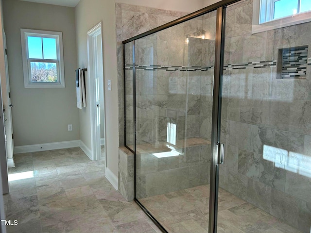 bathroom featuring a shower with shower door