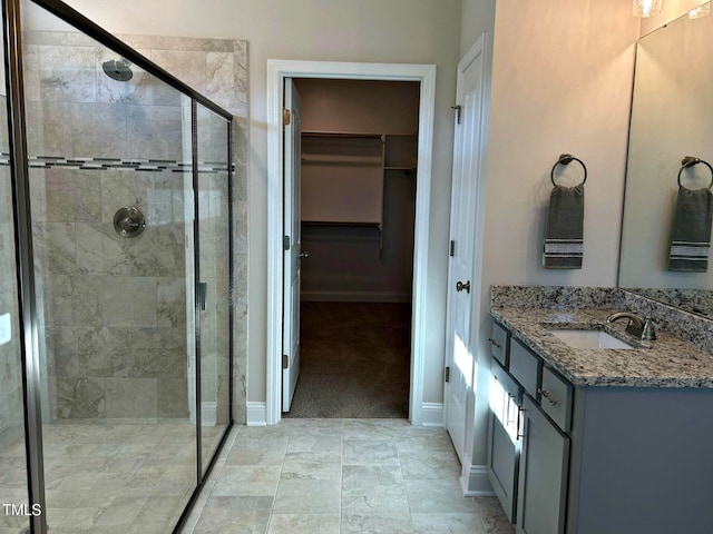 bathroom featuring vanity and a shower with shower door