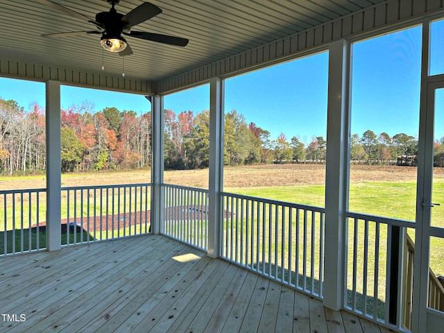 unfurnished sunroom with ceiling fan and wooden ceiling