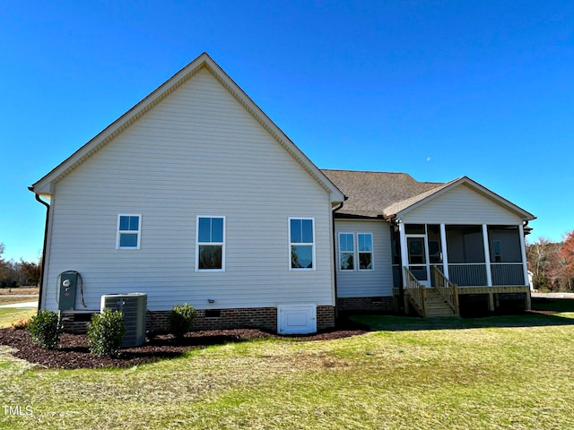 back of property featuring central AC, a sunroom, and a yard