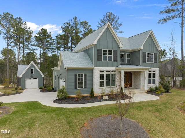 view of front facade with a front lawn, an outdoor structure, and a garage