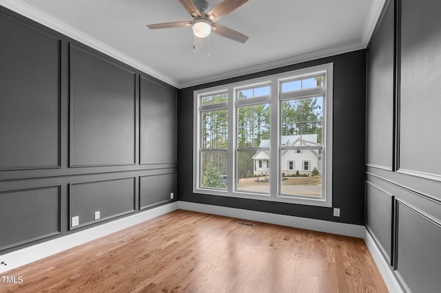 unfurnished room featuring ceiling fan, crown molding, and light hardwood / wood-style floors