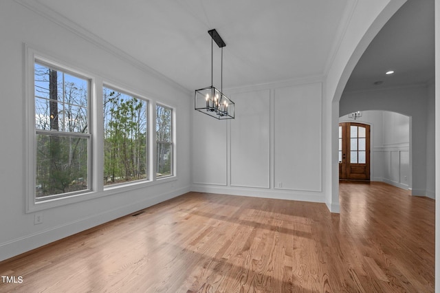 unfurnished dining area featuring crown molding, hardwood / wood-style floors, and plenty of natural light