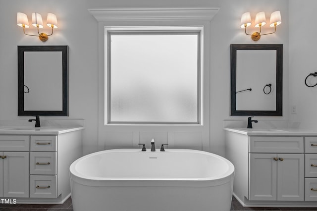 bathroom featuring ornamental molding, vanity, a tub, and tile patterned floors