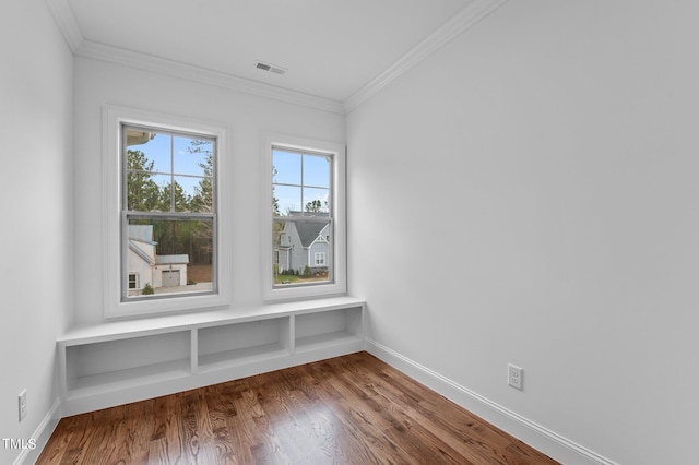 unfurnished room featuring hardwood / wood-style flooring and ornamental molding