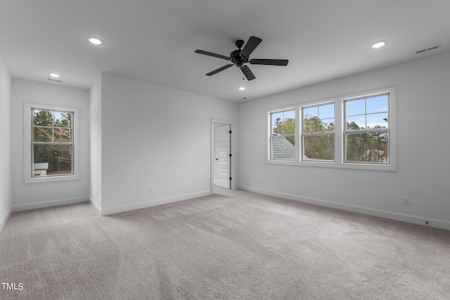 unfurnished room with light carpet and ceiling fan